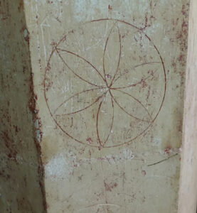 Daisywheel engraving in wall